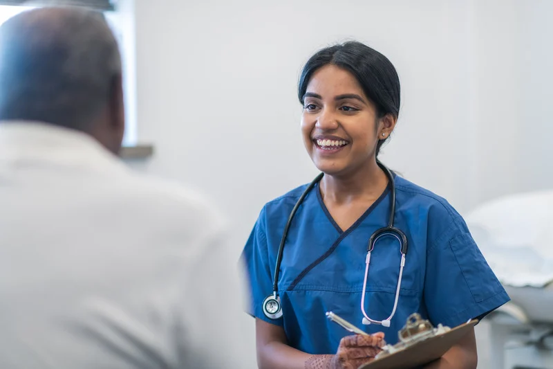 kind doctor meets with elderly patient